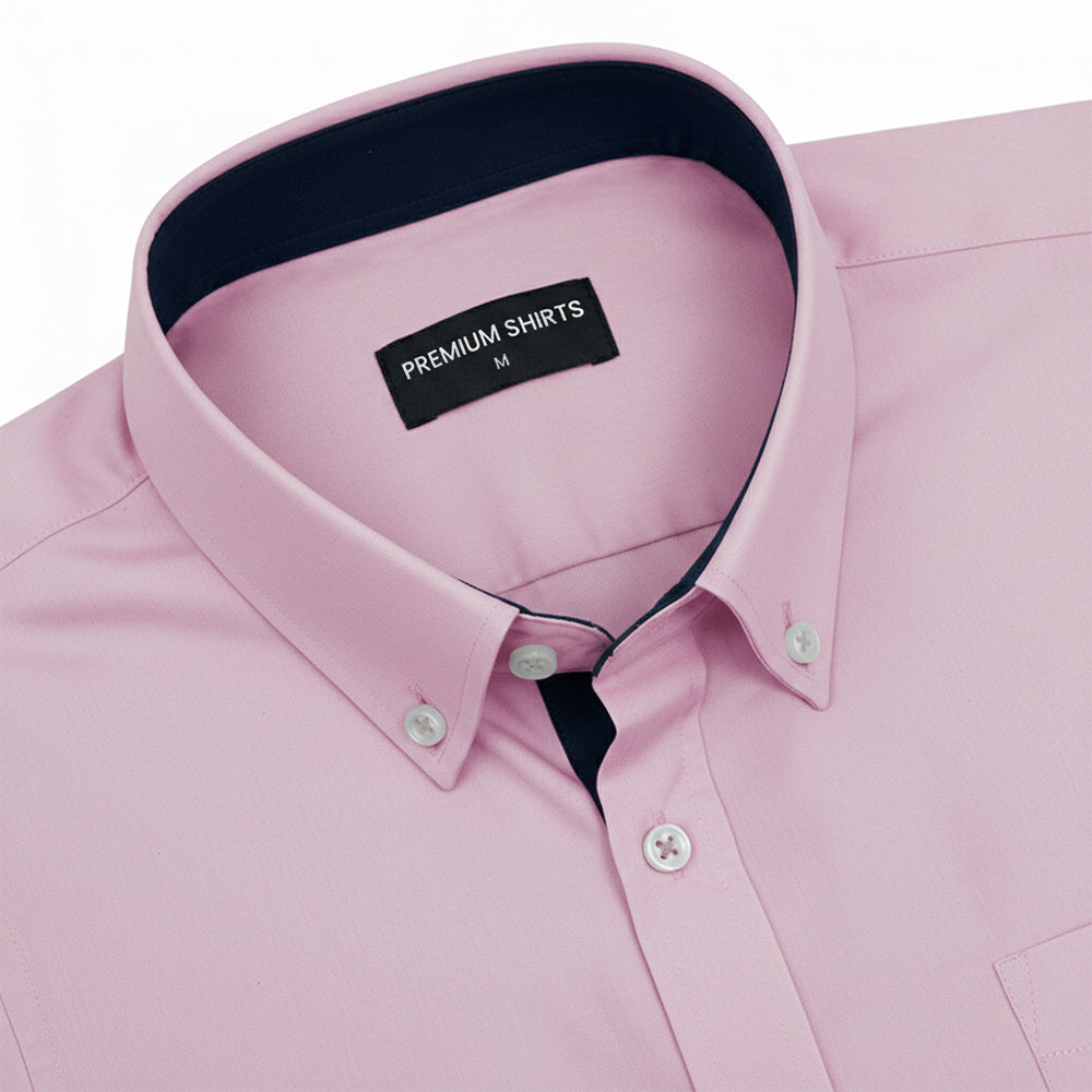 Pink dress shirt with Navy blue collar and cuff on a white background