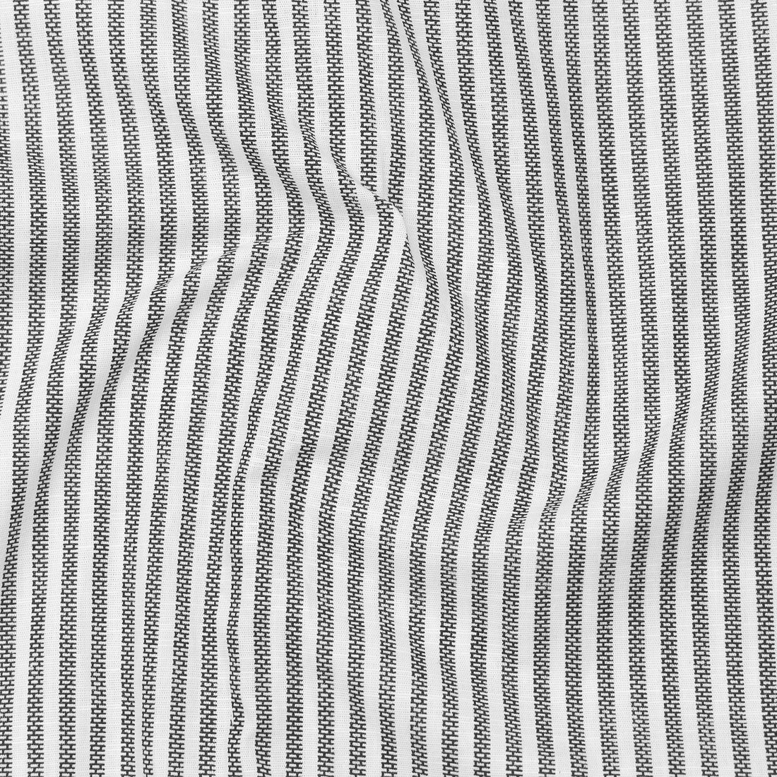 Folded black and white striped shirt with a visible brand label on a white background