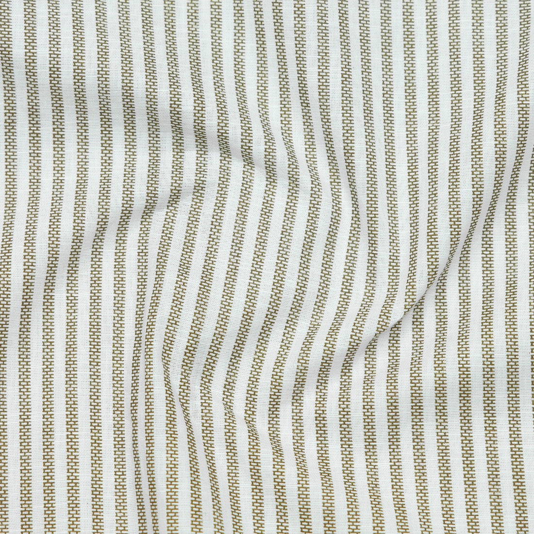 Folded green and white striped shirt with a label on a white background