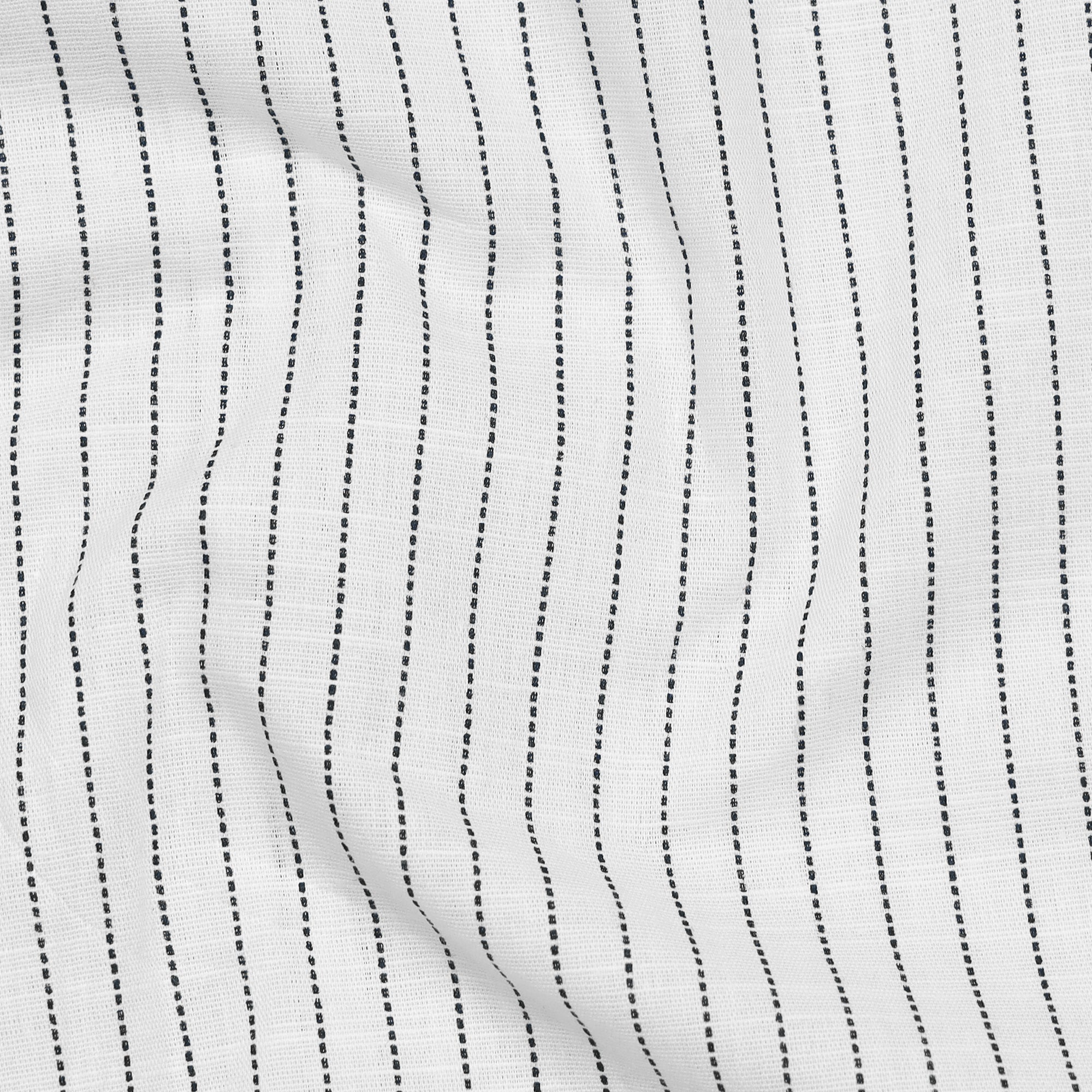 Close-up of white fabric with black parallel lines