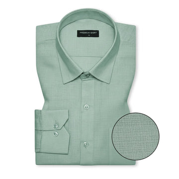 Green dress shirt with close-up of fabric texture on a white background